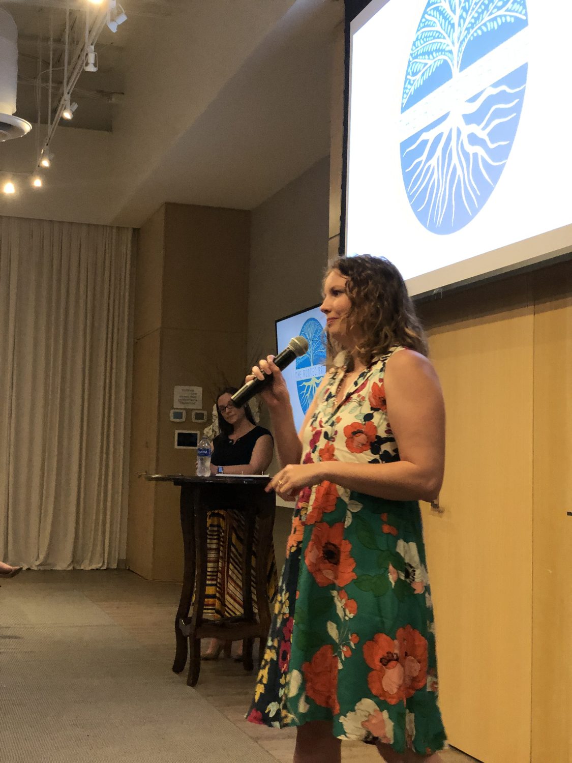Amy Green speaking on stage